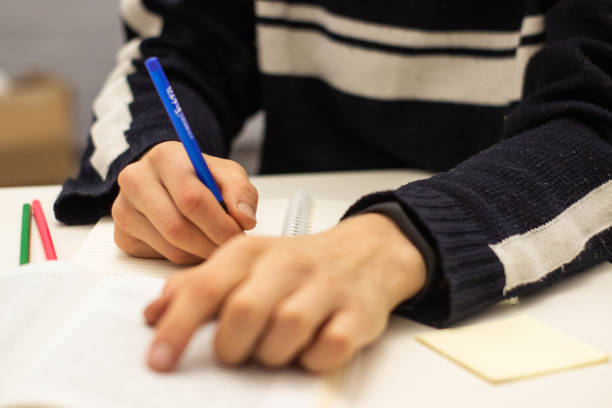 istock Hand writing on white paper. Education and business concept 1090860920