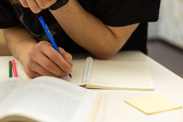 istock Hand writing on white paper. Education and business concept 1090861070