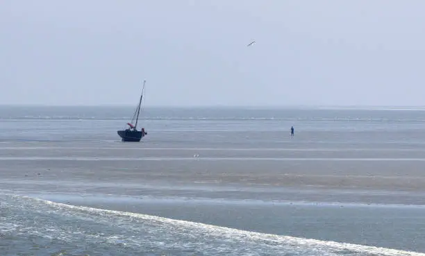 Beached sailing boat at the dutch coast