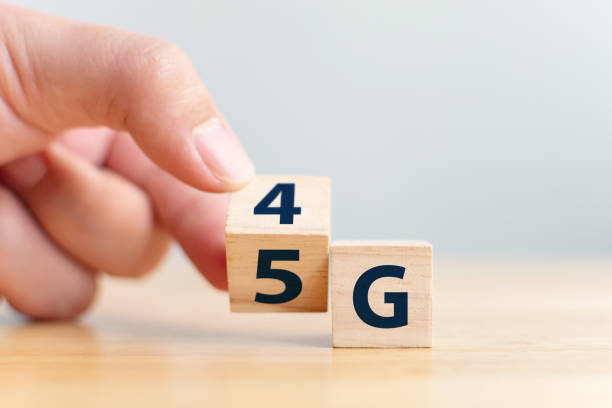istock 5G (5th Generation) network connecting technology future global. Hand flip wood cube change number 4G to 5G 1090869868