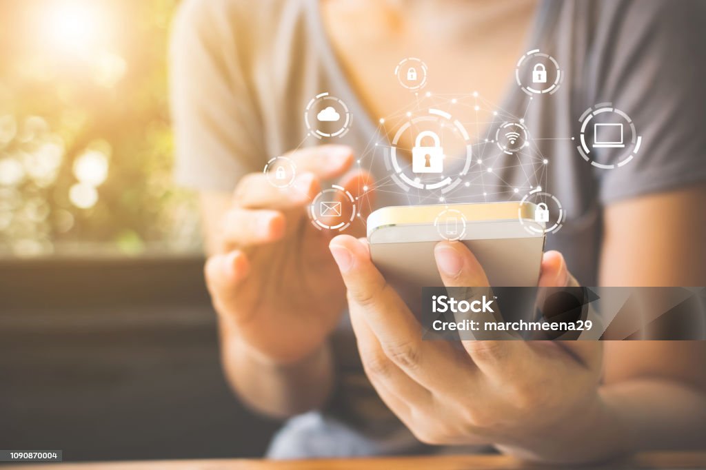 Woman using smartphone with icon graphic cyber security network of connected devices and personal data information Security Stock Photo