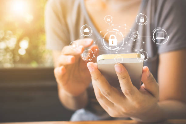 Woman using smartphone with icon graphic cyber security network of connected devices and personal data information Woman using smartphone with icon graphic cyber security network of connected devices and personal data information privacy stock pictures, royalty-free photos & images