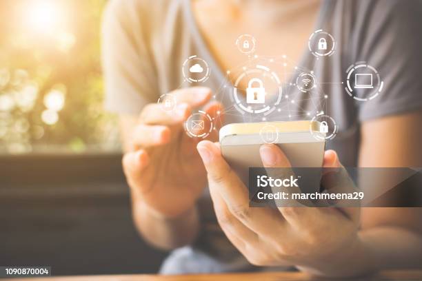 Woman Using Smartphone With Icon Graphic Cyber Security Network Of Connected Devices And Personal Data Information Stock Photo - Download Image Now