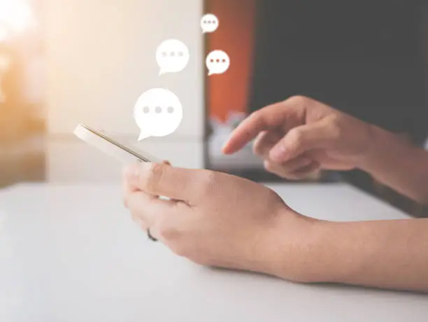 Photo of Hand of woman typing text on mobile smartphone. Online live chat chatting on application communication digital media website and social network