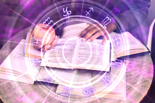 istock Hands holding glowing zodiac wheel book 1090872516