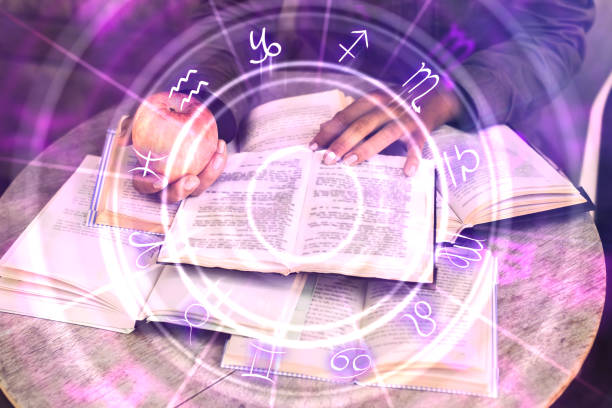 Hands holding glowing zodiac wheel book Close up of hands holding glowing book with zodiac wheel. Magic and astrology concept. Double exposure cosmos of the stars of the constellation capricorn and gems stock pictures, royalty-free photos & images
