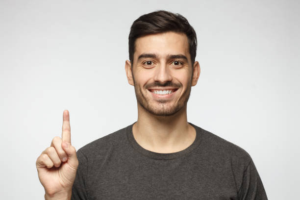 istock Handsome young man pointing up with his finger isolated on gray background 1090878552