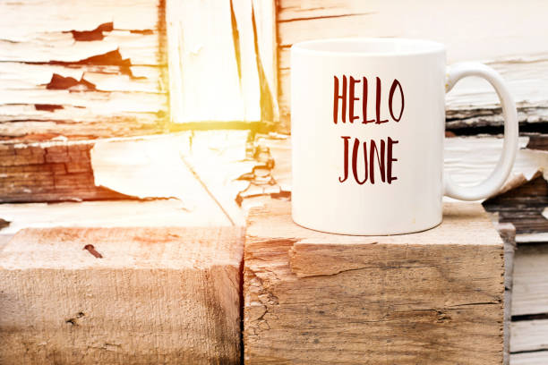 istock text HELLO JUNE on cup of aromatic coffee on wooden cube 1090881678