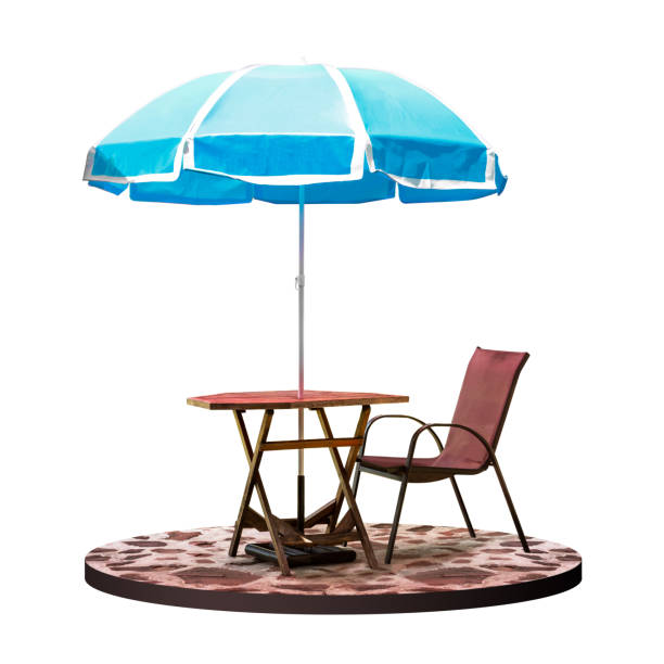 Shadow of an umbrella and patio table arrangement cast onto a rustic farm house at sunrise as seen long the touristic wine making region of Saint-Emilion, France