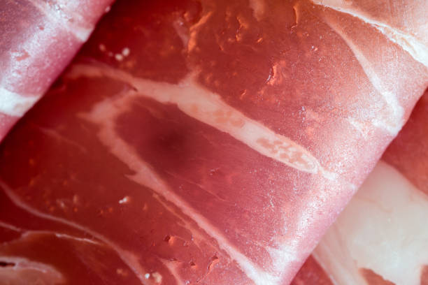 A macro shot of a tasty slice of prosciutto, front view, studio shot.