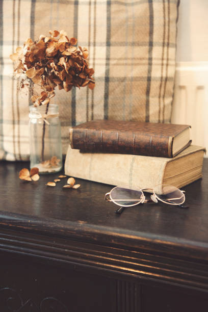 istock Vintage style ladies reading glasses and old book 1090885886