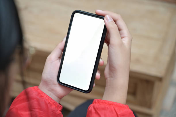 istock Girl with a blank screen mobile smartphone in her hands 1090895884