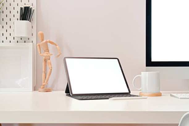istock Modern office workplace with blank screen tablet mockup, pc and stylish supplies on the office desk. 1090896042