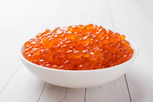 istock red salmon caviar in a plate on a white table. 1090896722