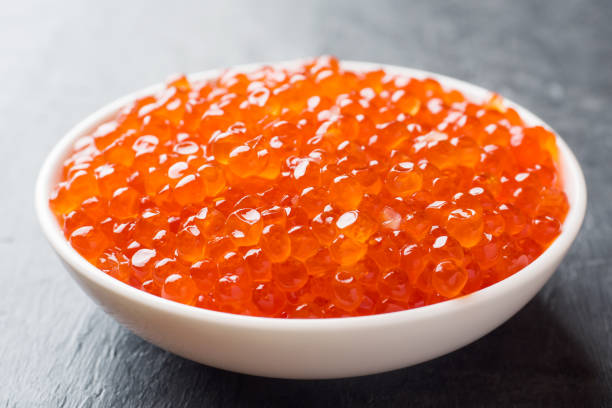 istock red salmon caviar in a plate on a dark table. 1090903442