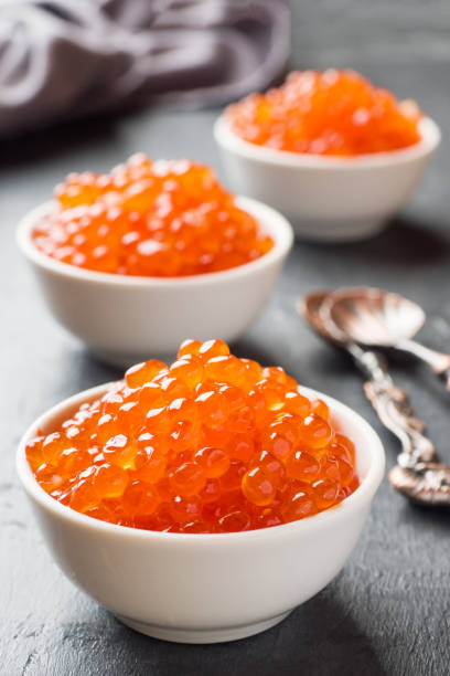 istock red salmon caviar in a plate on a dark table. 1090903466