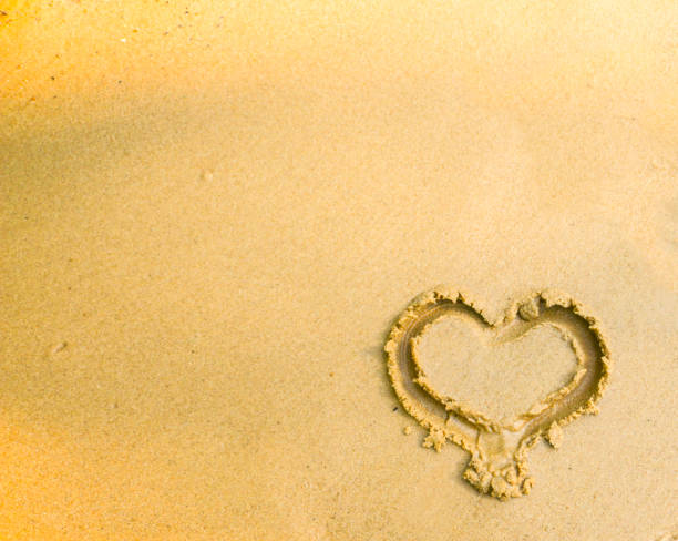 istock beautiful tender heart painted on wet gold sand 1090907778
