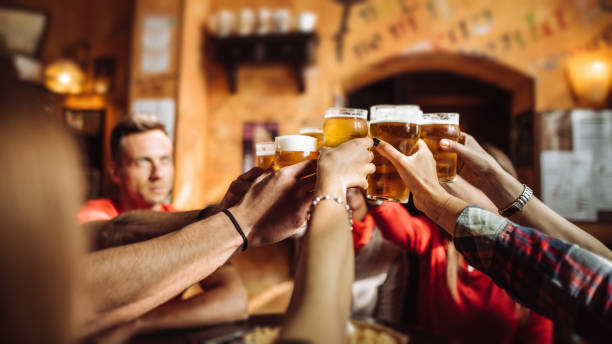 istock people talking and toasting in a pub with the beers 1090908724
