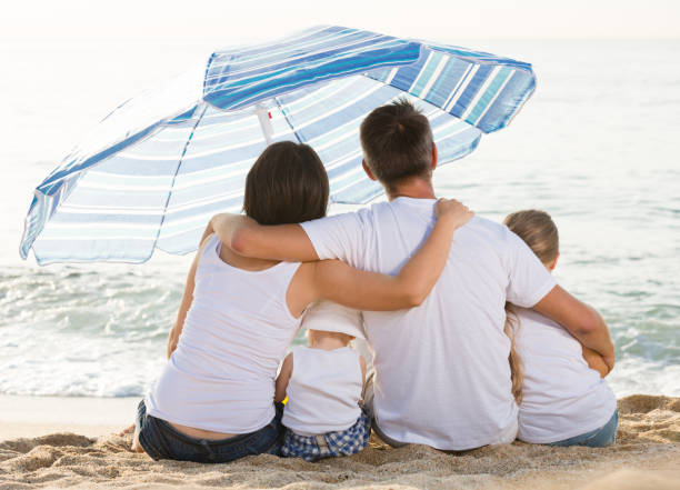 istock Young family and kids sitting with back forward 1090915812