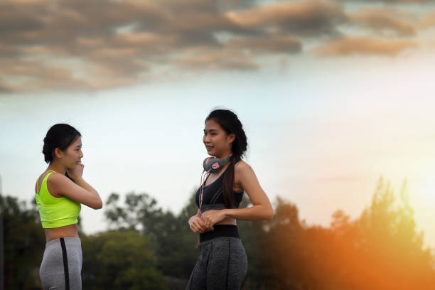 istock Two sprot girls talking fun and relaxing in park 1090915860