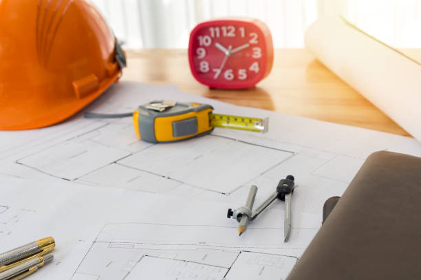 istock Measurement tool with helmet on blueprint, architectural concept 1090915934