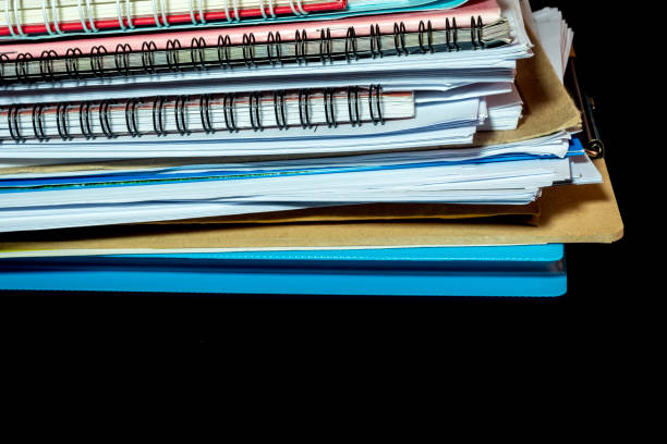 istock Stacked of office documents paper in the black background 1090916158
