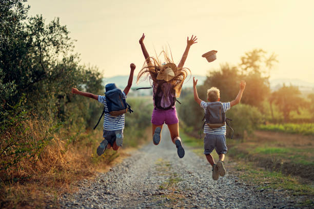 happy little hikers jumping with joy - recreational pursuit carefree nature vacations imagens e fotografias de stock