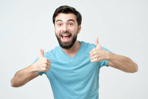 istock Smiling man showing both thumbs up and looking at camera. 1090924756