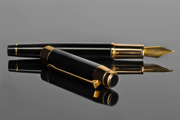 istock Elegant Fountain Pen on a Black glossy Surface 1090929540