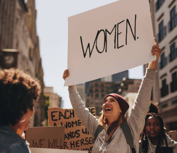 istock Happy woman protesting with hand written sign 1090929928