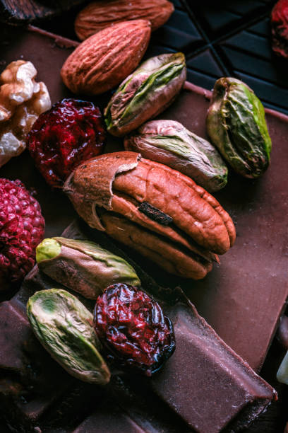 Close up of nuts and dried fruit with chocolate bars in old fashioned style