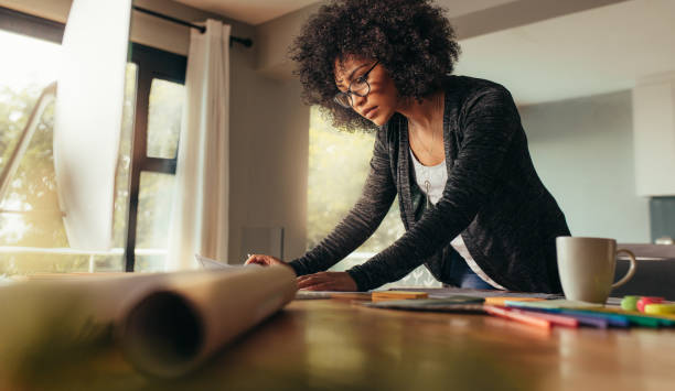 istock Young female architect working on a project from home office 1090930228