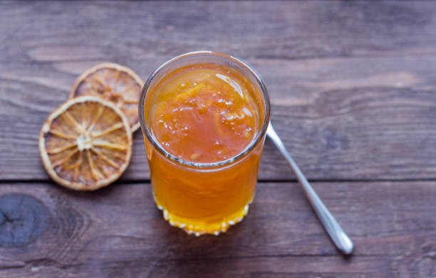 istock orange jam on wooden background, top view 1090932990