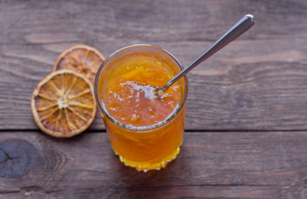 istock orange jam on wooden background, top view 1090935344