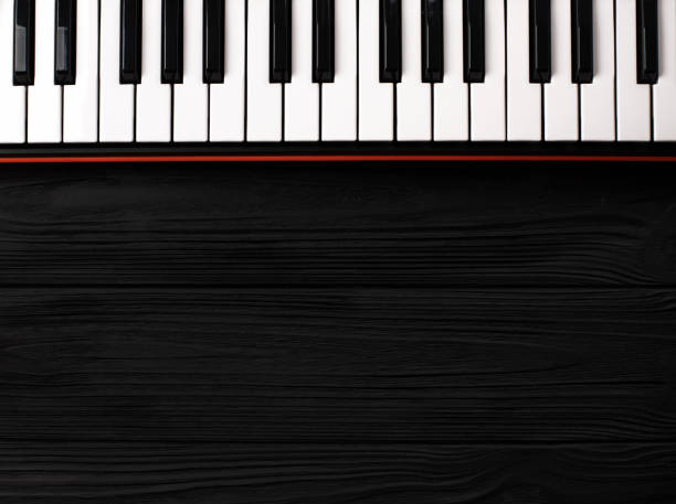 istock synthesizer keyboard on black wooden background 1090935738