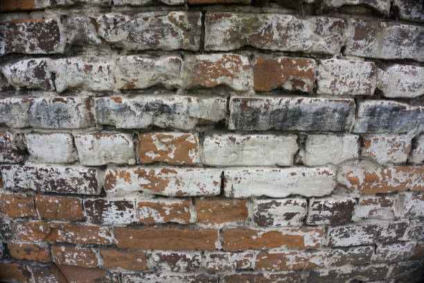 Cracked Dark Red Old Brick Wall Texture. Damaged Brown Abstract Blank Stonewall Background. Ruinous Brickwall Dilapidation
