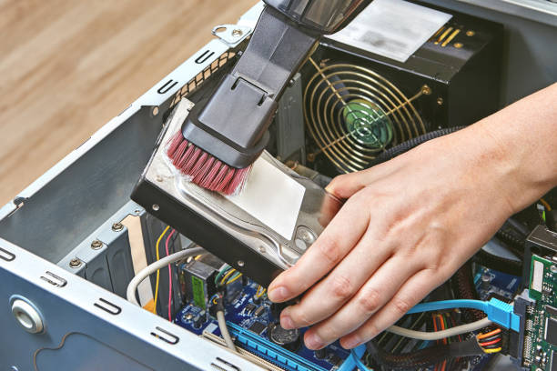 istock Repairman is cleaning HDD of computer system unit. 1090936008