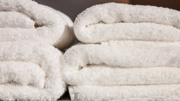 istock Stack of white folded towels background. Closeup view with details 1090936190