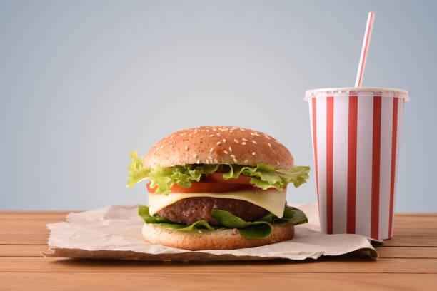 istock Beef burger on wooden table with soda gary backgorund 1090940354