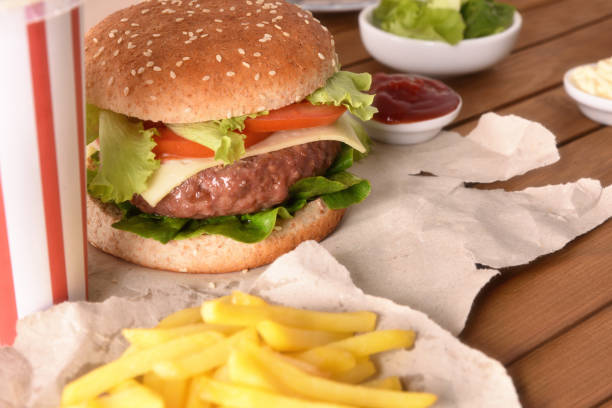 istock Burger on wooden table close up elevated view 1090941116