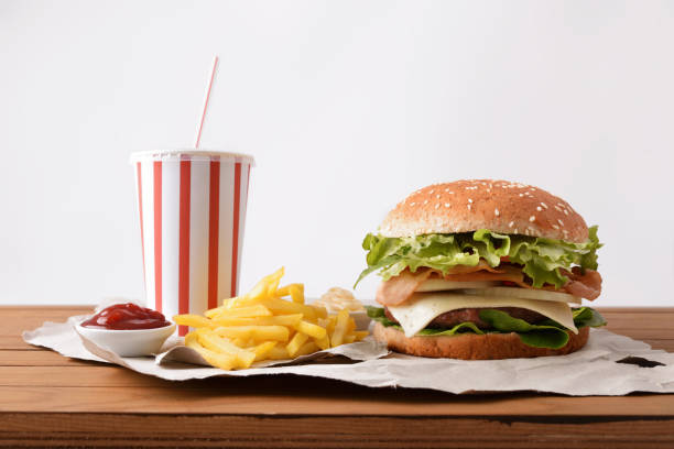 istock Beef burger with soda chips and souces on table white 1090941156