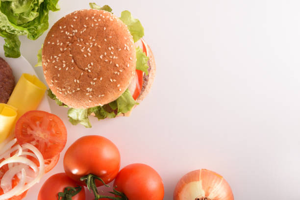 istock Homemade burger with ingredients on white table top 1090941166