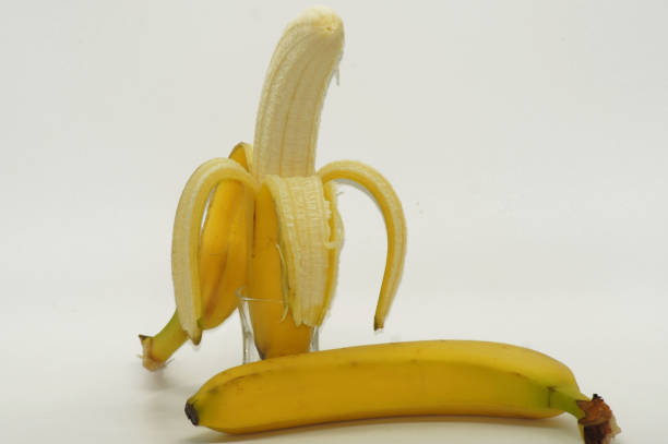 istock Banana semi-peeled free on white background 1090943784