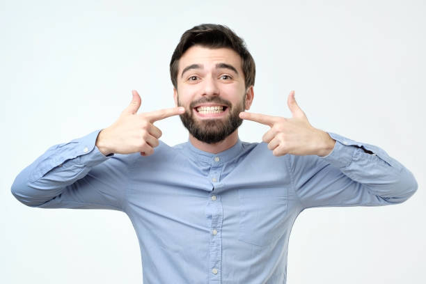 istock Hispanic man smiling confident showing and pointing with fingers teeth and mouth 1090945320