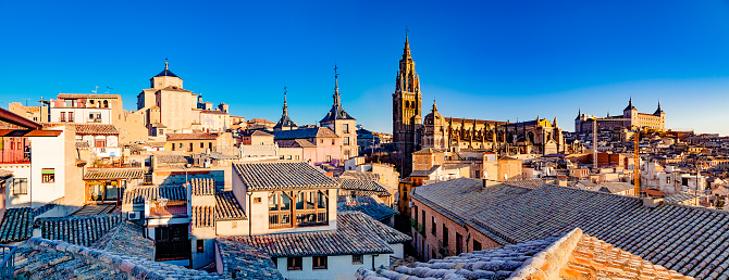 Panoramic view of Toledo Cathedral tower with old houses rooftop on foreground. Aerial view. DSRL outdoors photo taken with Canon EOS 5D Mk II and Canon EF 24-105mm f/4L IS USM Wide Angle Zoom Lens