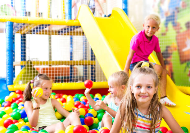 istock Girl playing with multicolored plastic balls 1090951354