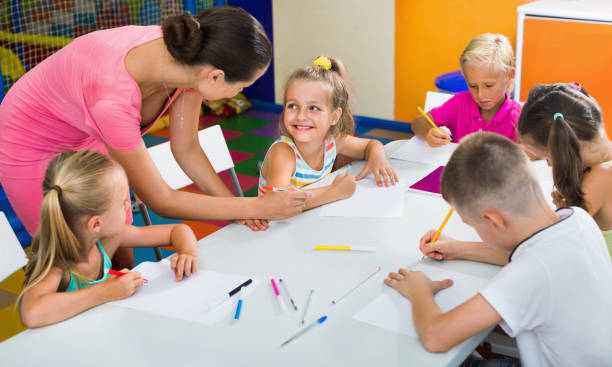 istock Kids drawing together with tutor at hobby group 1090951380