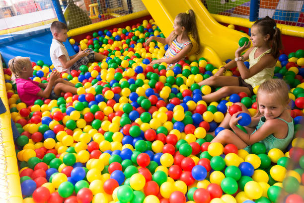 istock Group of kids playing on playground with plastic balls 1090951394