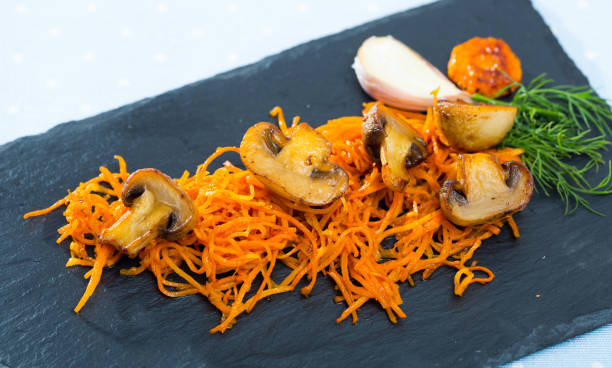 istock Slate of freshly fried mushrooms with carrot 1090952476