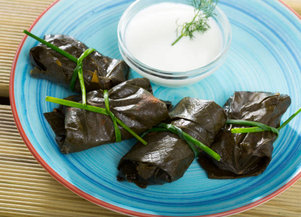 istock Grape rolls Sarni cooked in leaves and served with sour cream at plate 1090952514